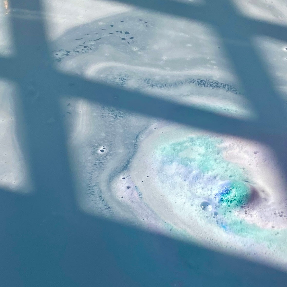 Mermaid Sugar Bath Bomb fizzing in a bath tub