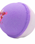 Purple and white bath bomb with pink specks on a white background