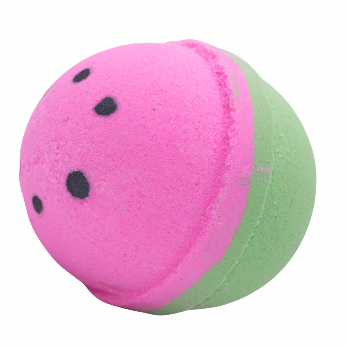 Pink and green bath bomb with black spots on a white background