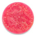 Pink textured soap bar on a white background