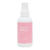 A white spray bottle with a pink label that reads 'spruce up spritz'.