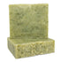 A bar of soap with a greenish color and exfoliating particles visible in the texture.