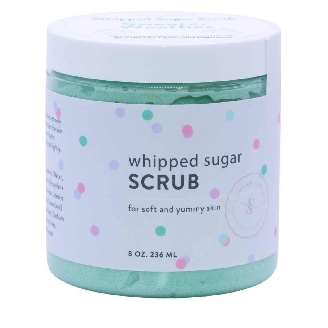 A jar of light green sugar scrub on a white background