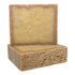 A bar of soap with a rough, textured surface, primarily in a fall edition shade of pumpkin-spice color.