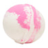 A bath bomb with a spherical shape, predominantly white with pink color swirls and speckles.