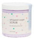 A container of Whipped Sugar Scrub with purple and pink dots on a white background, labeled for soft and smooth skin.