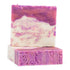 A bar of soap with a white base and purple top, with patterns and swirls on the surface.